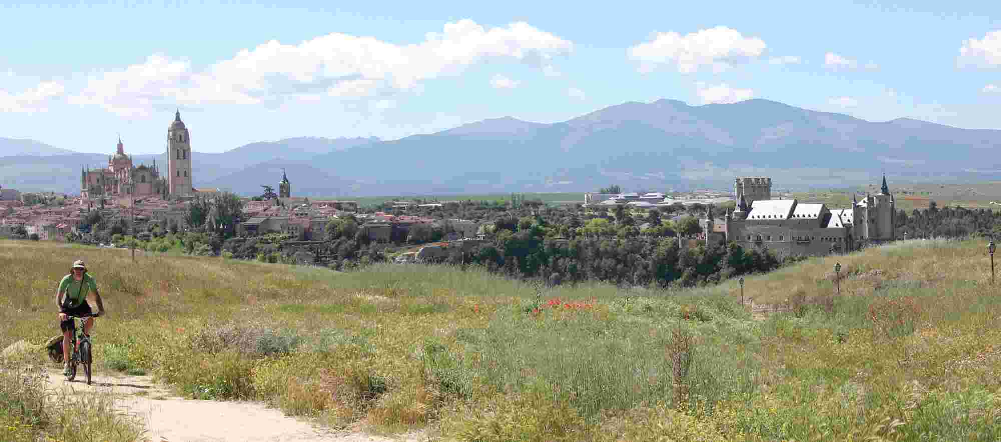 cyclist with a fantanstic panoramic view of Segovia in the background