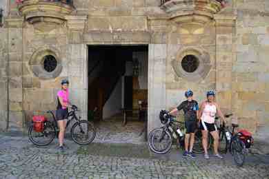 cyclists outside monument in santillana del mar