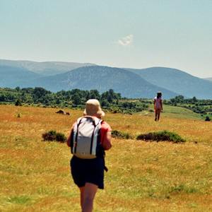 Woman walks leisurely in Spanish countryside