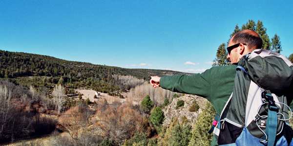a walkers points into the distance in a natural environment